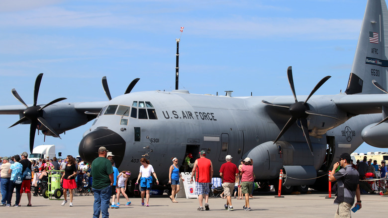 The Lockheed Martin WC-130J Hercules standing at an airport, surrounded by people