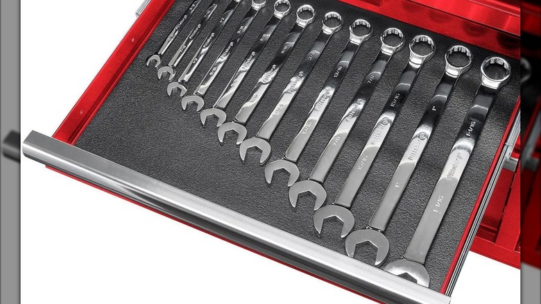 Open drawer of red Yukon 46-inch 9-Drawer Mobile Storage Cabinet filled with wrenches