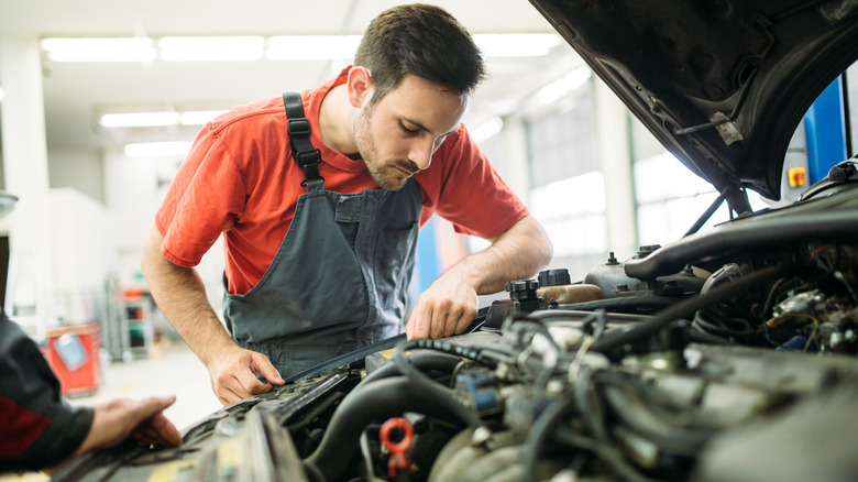 Mechanic examining engine bay