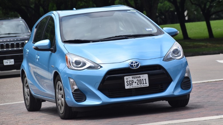 A blue Toyota Prius driving