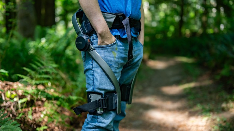 The Hypershell Pro X being worn on a hiking trail in the forest.