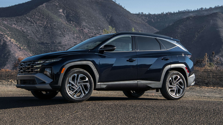 Black 2026 Hyundai Tucson Hybrid parked with mountains in distance