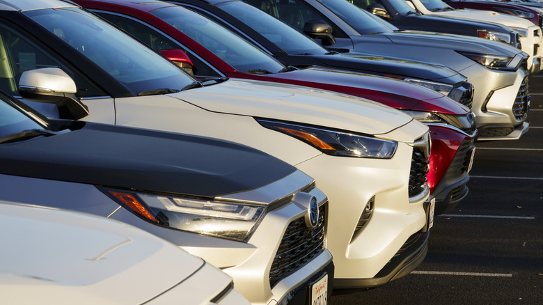 Close up view of a line of used Toyota SUVs parked on CarMax dealer lot.