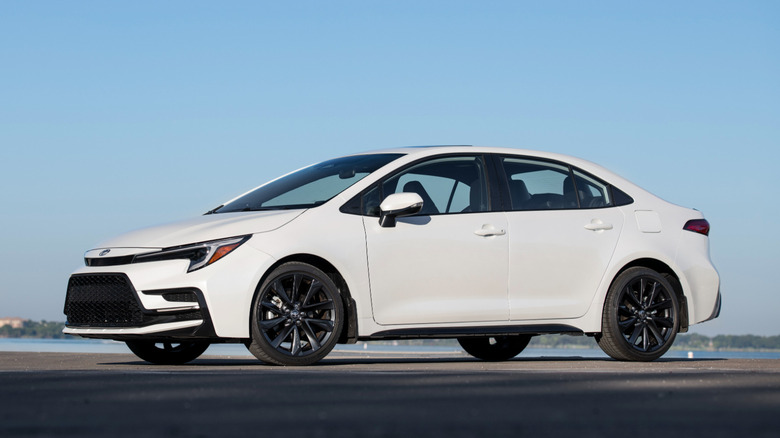 Front 3/4 view of white 2026 Toyota Corolla sedan.
