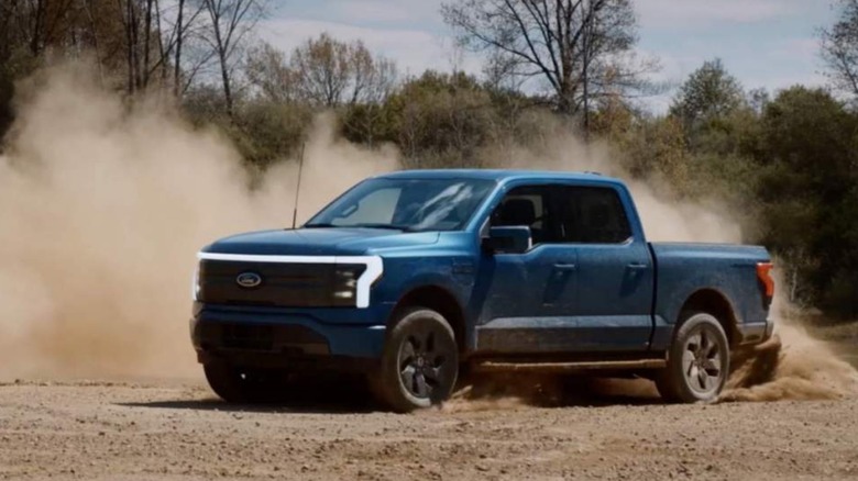 Ford F-150 Lightning Raptor driving on dirt