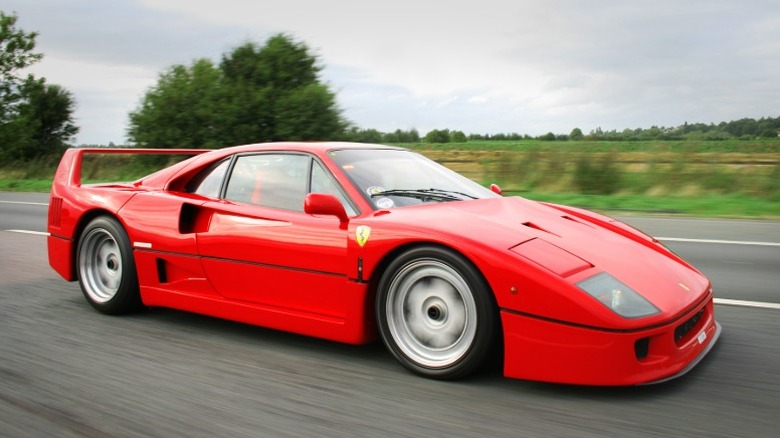 Ferrari F40 driving on a rural road