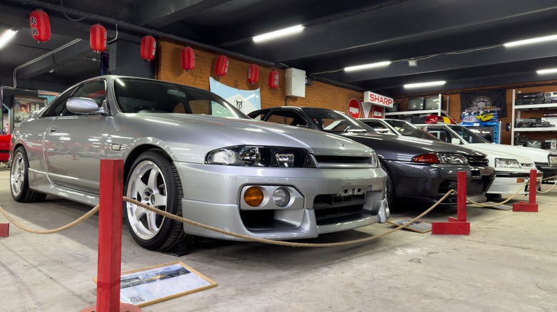 Silver and black Nissan Skylines on display