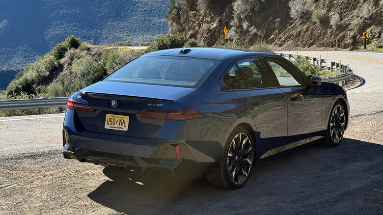 2026 BMW i5 xDrive40 rear 3/4 parked in the mountains