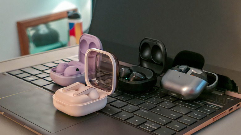 Samsung Galaxy Buds Pro, Buds2 Pro, Buds3 Pro, and Buds4 Pro on a laptop keyboard