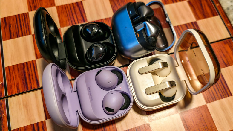 Samsung Galaxy Buds Pro, Buds2 Pro, Buds3 Pro, and Buds4 Pro on a chess board with cases open