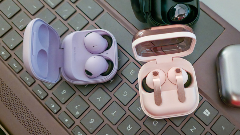 Samsung Galaxy Buds Pro, Buds2 Pro, Buds3 Pro, and Buds4 Pro on a laptop keyboard