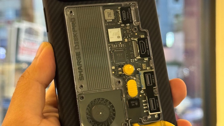 A Shargeek Disk Pro accessory attached to the back of an iPhone