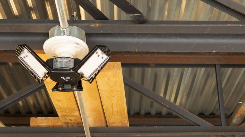 A GT-Lite garage LED bulb installed in a ceiling light socket.