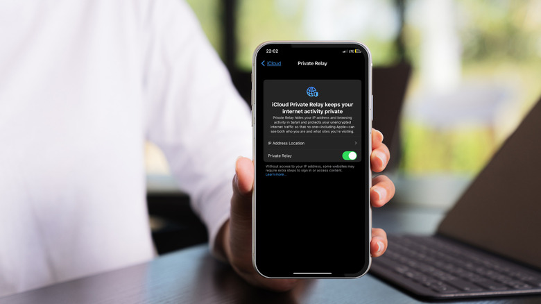 person holding iPhone Private Relay menu