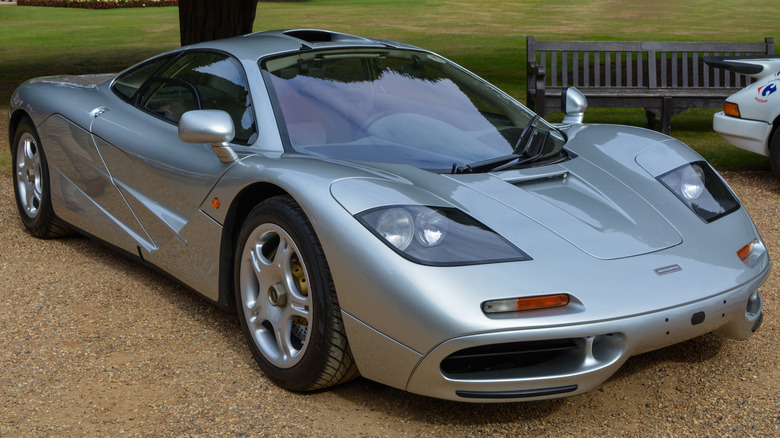 Silver 1996 McLaren F1 seen from front right parked outdoors at car show