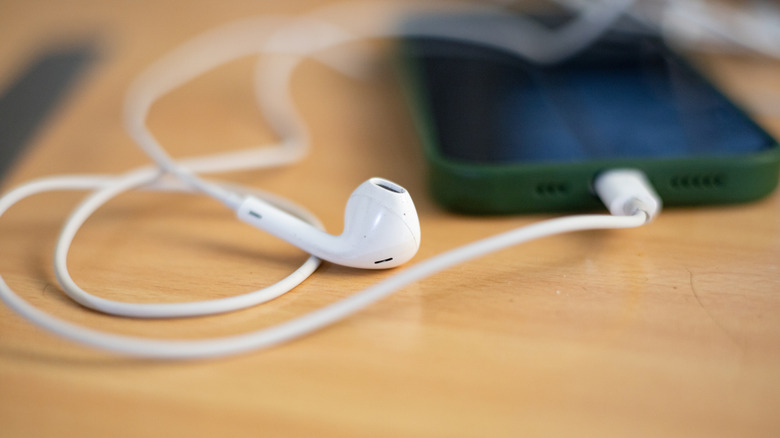Wired earbuds connected to smartphone