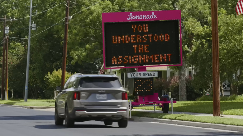 Lemonade's "Slow Sign" with a passing Kia driver