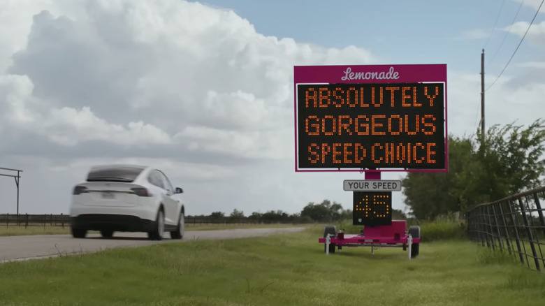 Lemonade sign displaying a message to a Tesla driver