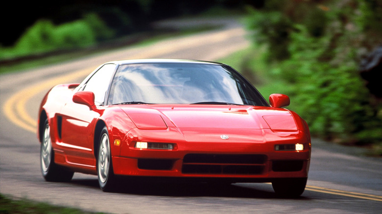 1993 Acura NSX driving at speed on national road, front-right 3/4 view