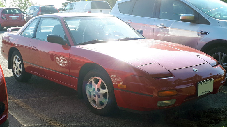 Nissan S13 240SX coupe parked in parking lot, front-right 3/4 view