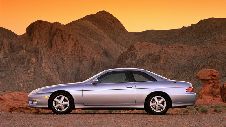 Lexus SC300 parked on desert backdrop during sunrise, left-side view