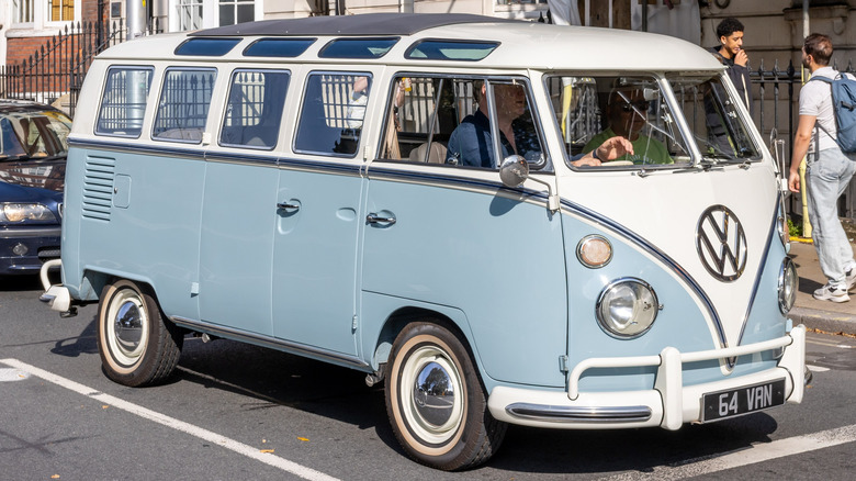 1964 Volkswagen Van in white and baby blue, idling by a crosswalk