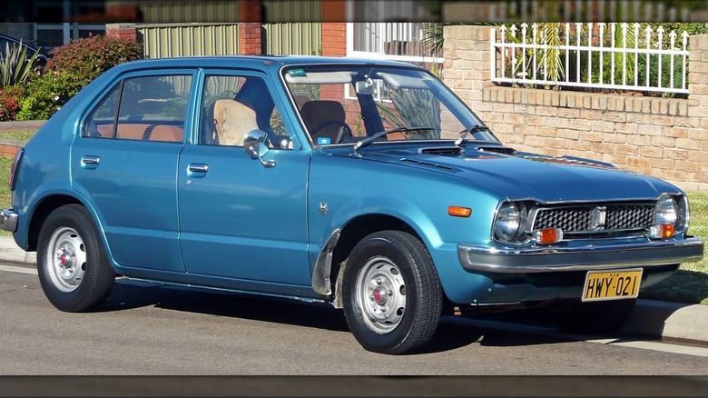 The 1973 Honda Civic hatchback in blue parked on a street.