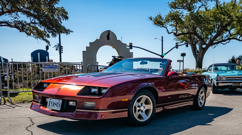 Person driving a Chevy Camaro IROC-Z in a car show