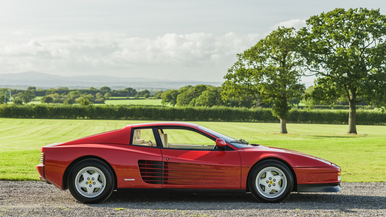 Picture showing a Ferrari Testarossa parked in the countryside