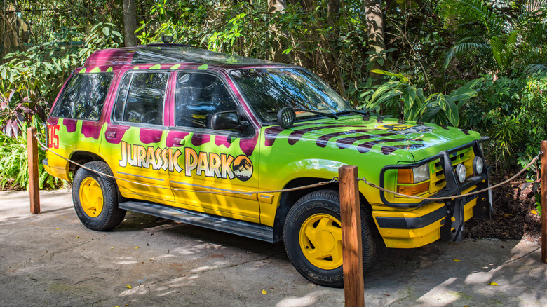 A parked 90s Ford Explorer tour car from "Jurassic Park" on display behind a cordon.