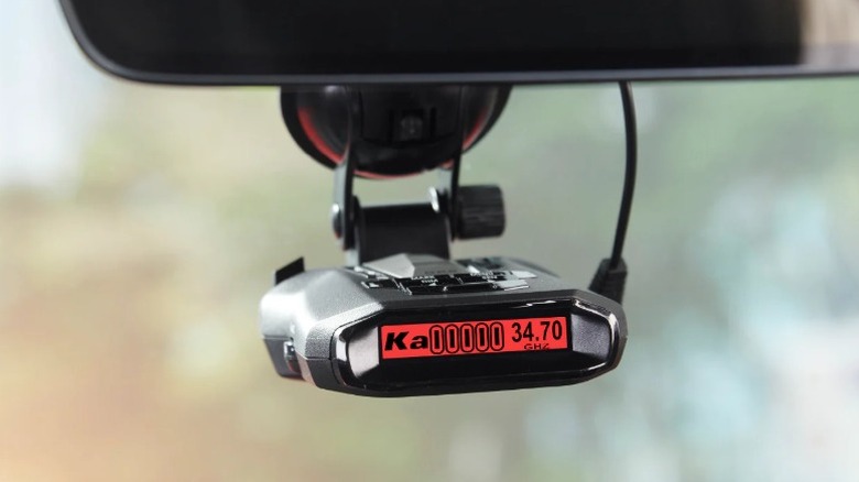 Cobra RAD 700i radar detector attached to a rear-view mirror