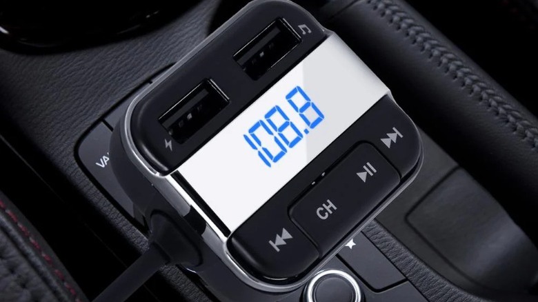 Pyle USA FM radio transmitter connected to a car's center console
