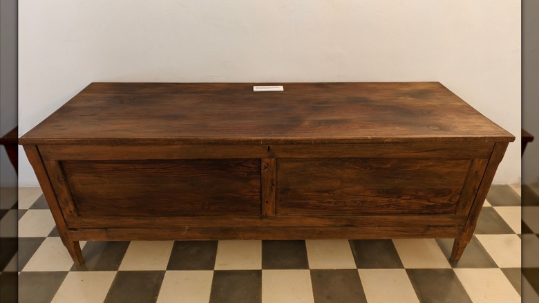 a wooden bench with a storage compartment underneath