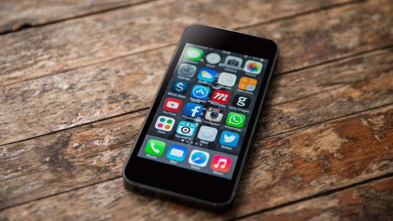 iPhone 5 with WhatsApp on home screen