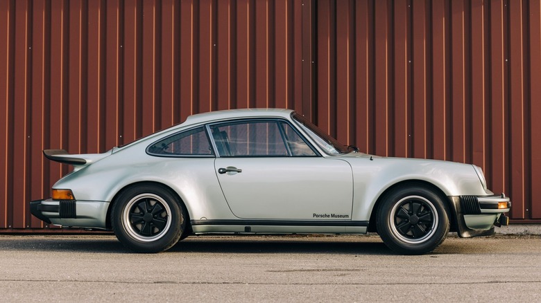 Side view of 911 Turbo on tarmac with shipping container in background