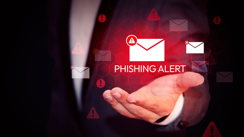 A red glowing phishing alert message hovering over a hand.