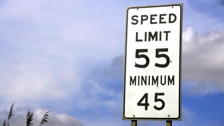A highway speed limit sign showing maximum and minimum speeds.