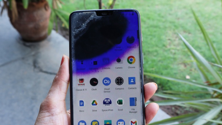Large purple spot radiating from a corner damage on an Android phone