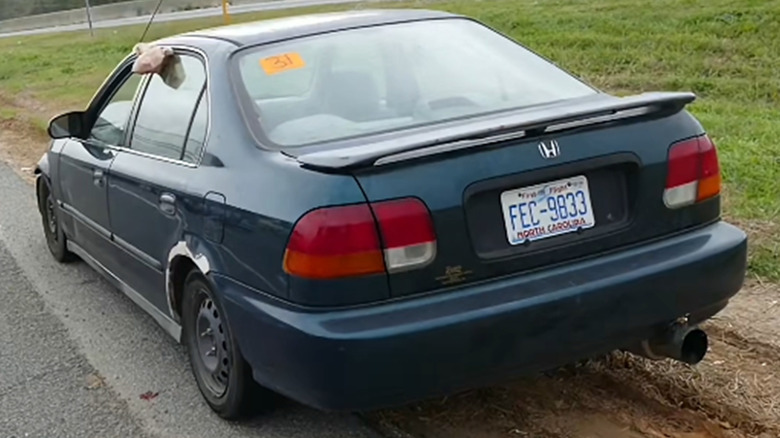 car with white cloth hanging out the window in north carolina