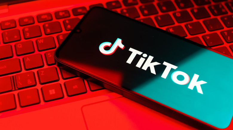 TikTok app opening on a keyboard under a red light