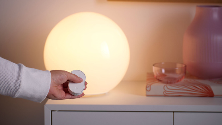 Person using an IKEA remote to control lights