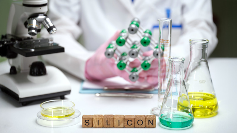 A scientist at a lab table.