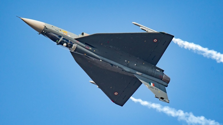 HAL Tejas aircraft upside down executing an evasive maneuver in flight