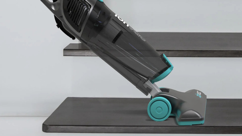 The Tzumi ionvac Zipvac in its stair vac mode, vacuuming a single gray step