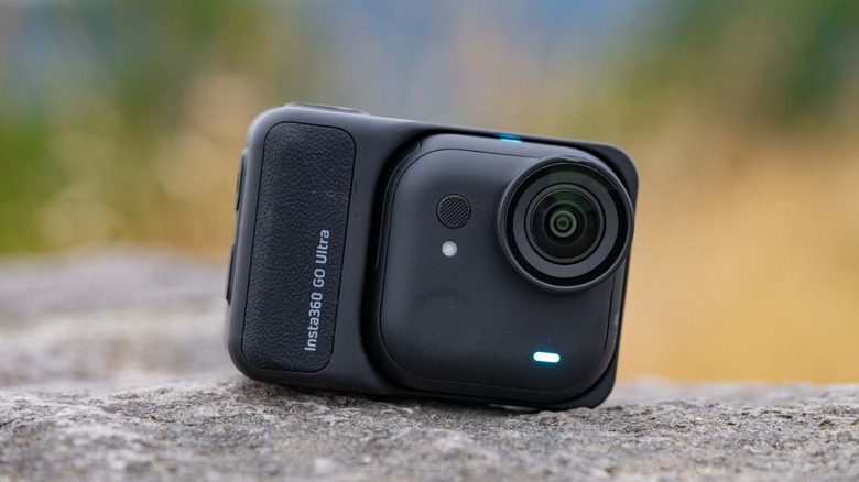 The Insta360 Go Ultra sitting on a rock.