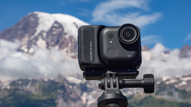 The Insta360 Go Ultra in front of a glacier covered mountain.