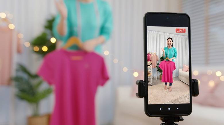 A woman with shopping bags on a phone