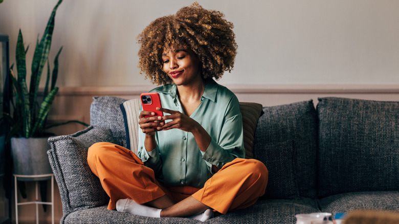 woman happily using iphone