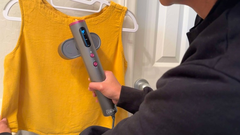 Author using the Jack & Rose travel steamer on a blouse