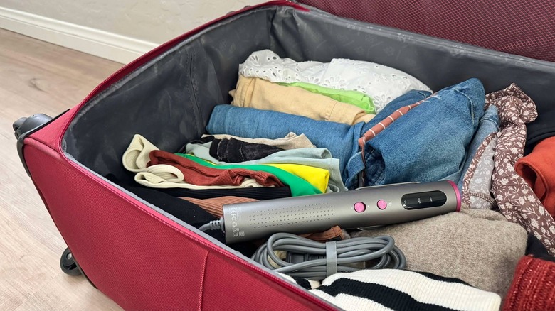 The Jack & Rose travel steamer is inside a piece of lugage along with clothing